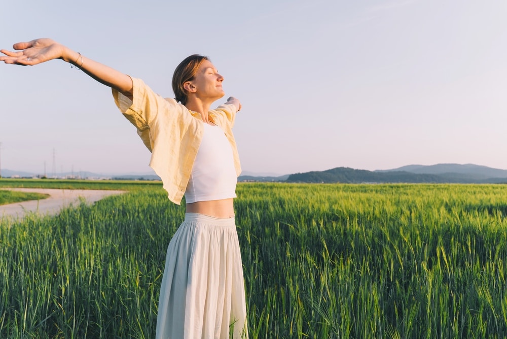 Happy,Woman,Is,Breathing,Outstretched,Arms,In,Nature,In,Sunset.